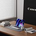 Modern Laptop With Colorful Screen On Wooden Desk Coffee Cup Books And Canon Logo