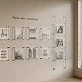 Paintings Display With Framed Black And White Photos On Beige Wall Near Window Blinds