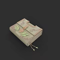 Light Green Decorative Book With Intricate Leaf Patterns And Tassel Accent