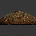 Freshly Baked Round Brown Bread With Oats And Seeds On Crusty Surface