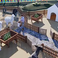 Farm Enclosure With Colorful Fence Sheep Huts Person White Stork And Planter Boxes