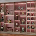 Decorative Ornaments Collection With Sculptures Vases And Figurines In Wooden Display Cabinet