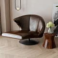 Brown Leather Leisure Chair With Curved Design And Wooden Side Table In Living Room