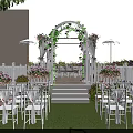 Detached Villa Outdoor Area With Red Brick Exterior White Arbor Vines Greenery And Lawn Chairs
