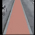 Urban Road Infrastructure With Two-Way Lanes Red Brick Pavement And Parked Cars
