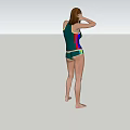Woman in Green Swimsuit Standing on Green Grass with Hands on Head and Trees Around