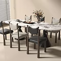 Round Marble Dining Table With Gray Chairs And Flower Vase Centerpiece Decoration