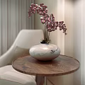Elegant White Vase With Purple Flowers On Round Wooden Table Near Beige Chair And Curtain