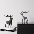 Black And White Deer Sculptures Displayed On Shelves Against White Background