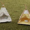 White and Yellow Tipi Tents with Pillows and Decorative Tassels on Green Grass