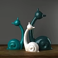 Snail Shaped Decorative Ornament Set With Green And White Design On Wooden Tabletop