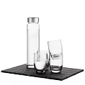 Clear Glass Water Bottle And Drinking Glasses On Black Slate Tray