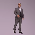 A Man Standing in Gray Suit with White Shirt and Black Vest on Gray Background