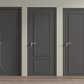 Three Gray Hinged Doors with Varied Panel Designs and Gold Handles in Interior Space