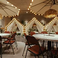 Cozy Restaurant Interior With Tents String Lights Round Tables Red Chairs And Straw Umbrellas