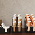 Brown Paper Cups With White Lids And Gold Accents In Black Organizers On Wooden Tabletop