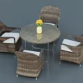 Round Outdoor Table with Wicker Chairs and White Cushions and Vase with Yellow Flowers