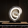 Metallic Spiral Sculpture With Perforated Pattern On Wooden Base In Dark Background