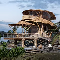 Bamboo Waterfront Guesthouse With Unique Roof Design Wooden Deck And Palm Trees
