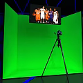Modern Exhibition Space With Geometric Ceiling Blue Lighting And Red Displays