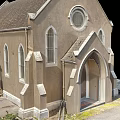 Traditional Church Building With Steeple Tower Brown Exterior Gray Roof Round Window And Arched Doorway