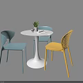 Modern Round Table and Chair Set with Blue Yellow Chairs White Cup and Potted Plant