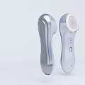 Silver Handheld Facial Cleansing Devices With Power Button And Massage Head Design