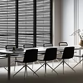 Modern Conference Room Interior Featuring Long Table Black Chairs Window Blinds Vase And Green Plants