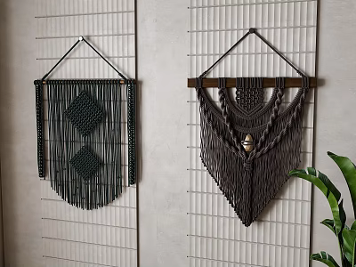 Two Handmade Macrame Wall Decor Pieces on Gray Grid Panel Wall with Green Plant Accent 3d model