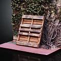Wooden Pallet Leaning Against Ivy Covered Wall On Red Stone Floor