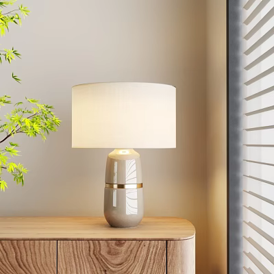 Stylish Ceramic Table Lamp With Cream Lampshade Gold Trim On Wooden Table Near Green Plant 3d model