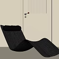 Black Modern Curved Lounge Chair In Minimalist Interior With White Door And Light Wall