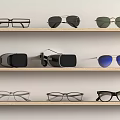 Different Styles of Eyeglasses Sunglasses and VR Headset on Display Shelves