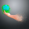 Man hand holding green polyhedron with orange particles splashing around