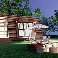 Wooden Cabins in Scenic Setting With Green Grass Trees and Outdoor Chairs