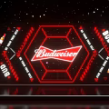 Budweiser Themed Stage With Red Neon Logo Beer Bottles And Geometric Design Backdrop