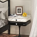 Elegant Black And White Bedside Table With Framed Picture Books And Lemon Bowl