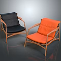 Two Stylish Modern Accent Chairs With Black And Orange Cushions And Wooden Frames
