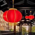 Red Lanterns With Golden Tassels Hanging Under Traditional Wooden Building Eaves