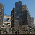 Vibrant Commercial Street With Glass Buildings Starbucks Shops Pedestrians Trees And Greenery