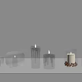 Burning Candles In Glass Holders With Various Shapes On White Shelf Background