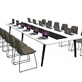 Long Conference Table With Laptops And Chairs In Office Meeting Setting