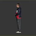 Man Standing in Navy Blue White and Red Hoodie With Gray Pants and White Shoes