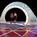 Event Entrance with Arched Lighting Structure and Reflective Geometric Floor Design where Two People Stand