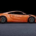 Orange Sports Car With Sleek Aerodynamic Body Black Accents Rear Spoiler And Alloy Wheels