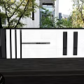 Modern Building Exterior Wall With White Facade Black Accent Lines And Trees Near Garage Area