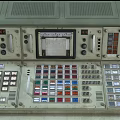 Industrial Control Console With Multiple Displays Control Panels Buttons And Green Beige Design