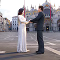 Couple In Wedding Dress And Suit Holding Hands At Venetian Square