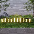 Modern Outdoor Lights Glowing In Green Grass With Trees Rocks Gray Wall And Stone Tiles