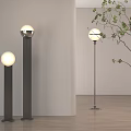 Modern Floor Lamps In Interior With White Spherical Lampshade Black Stand And Green Plant Branches